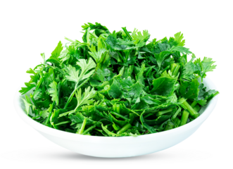Chopped parsley leaves in a ceramic bowl isolated on a white background