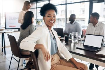 Portrait, meeting and a black woman in a business boardroom with her team for a strategy presentation on laptop mockup screen. Workshop, training and collaboration with a female sitting at a table