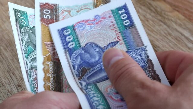 Myanmar currency, Counting banknotes in hand, Money Burmese kyat, financial concept