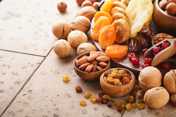 Tu Bishvat celebration concept. Mix of dry fruits and nuts almonds, hazelnuts, walnuts, apricots, prunes, cherries, raisins, dates, apples, figs over wooden table. Jewish holiday, new year of trees.
