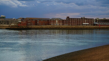 Panorama. Photo of eclectic mix of buildings along skyline positioned along the coastline. ...