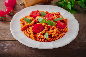 Fusilli pasta with tomato sauce and basil
