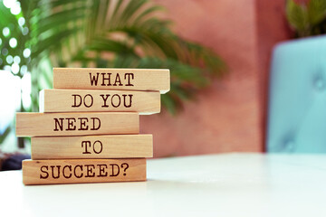Wooden blocks with words 'What Do You Need To Succeed?'.