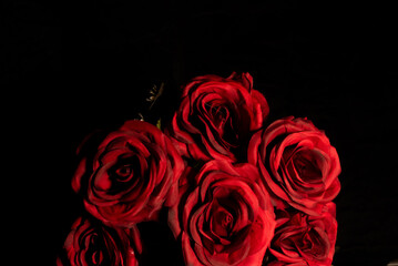Bouquet of red roses on black background 