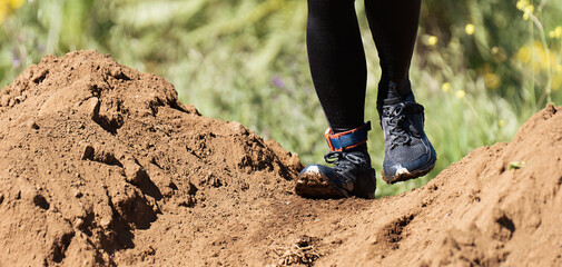 Trail running action close up of running shoes in action. Soaked running shoes	