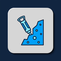 Filled outline Construction jackhammer and stone icon isolated on blue background. Vector