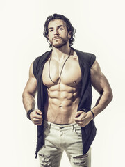 Fototapeta premium Confident, attractive young man with open vest on