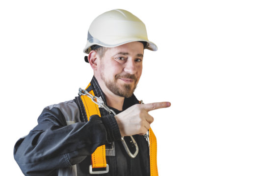Positive friendly bearded male builder in overalls, hardhat and goggles pointing with his finger. Isolated background.