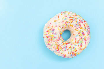 Fototapeta na wymiar Donut on light blue background, flat lay. Sweet food, dessert
