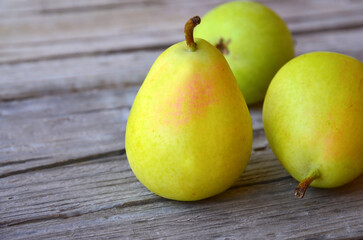 Fresh ripe organic pears on old wooden background.Pear fruits on a rustic table.Healthy eating,diet,raw food and nutrition or harvest concept.
Selective focus.