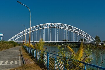 arch shaped road bridge over the river canal
