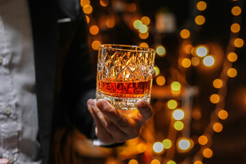 Closeup businessmen holding a glass of whiskey