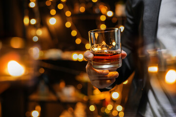 Closeup businessmen holding a glass of whiskey