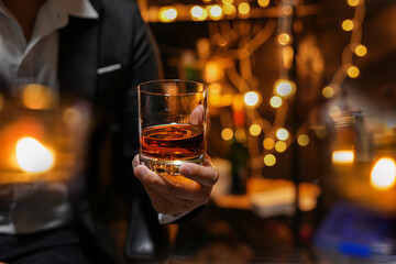 Closeup businessmen holding a glass of whiskey