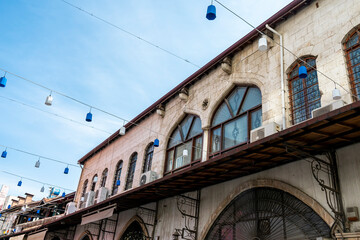 Traditional Antakya building in the old town with blue and white lights suspended on cables in the...