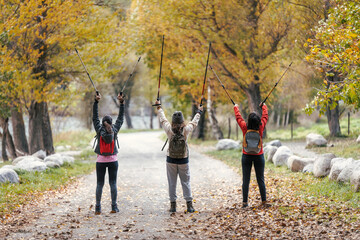 Beautiful family hikers with backpack walking while looking the landscape in the mountain