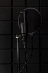 Black microphone on a black background.Music.Recording studio. Black on blac
