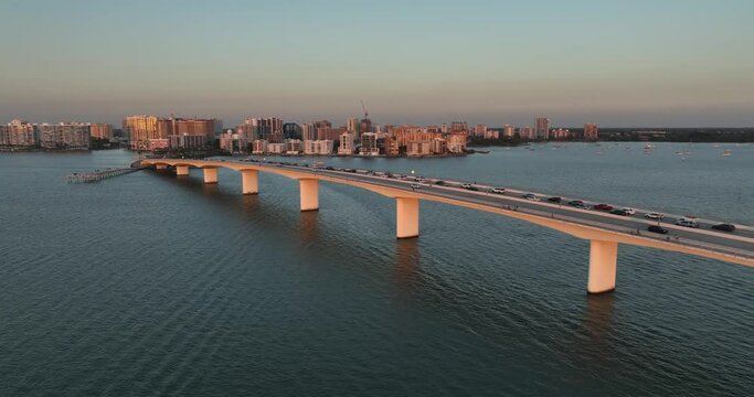 Evening aerial video of the Sarasota, Florida skyline and Ringling Parkway Bridge across Sarasota Bay	
