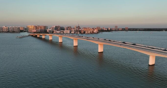 Evening aerial video of the Sarasota, Florida skyline and Ringling Parkway Bridge across Sarasota Bay	