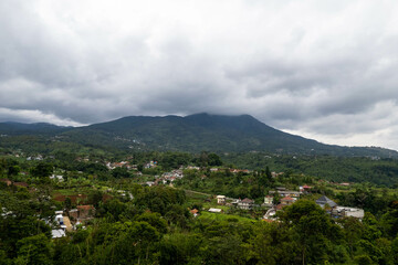 Fototapeta premium Rural and mountain landscape with heavy clouds