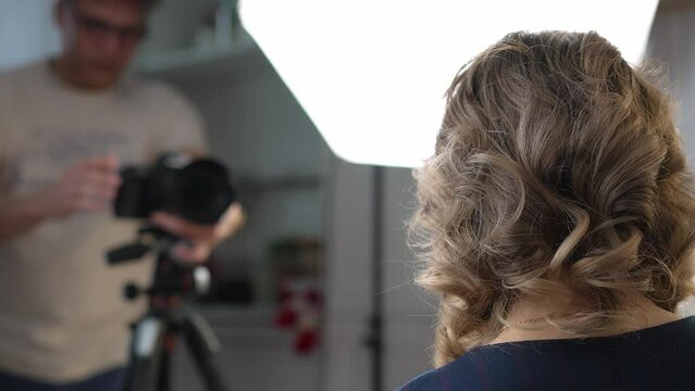 A business woman is filmed on a video camera for a blog. Video filming, online training.