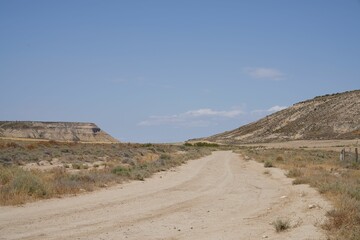 Daytime view of a road in a deserted area landscape