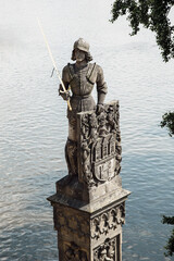 Vertical shot of the Statue of Knight Brunzwick, the mythical guardian of Charles Bridge in Prague