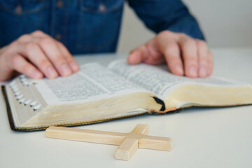 Christian catholic man concentrate on reading Holy Bible at home. Sunday readings.