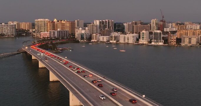 Evening aerial video of the Sarasota, Florida skyline and Ringling Parkway Bridge across Sarasota Bay	
