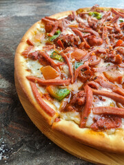 Freshly Baked pizza close view. BBQ Chicken Pizza on Wooden board. Delicious tasty fast food Italian traditional on wooden board table.