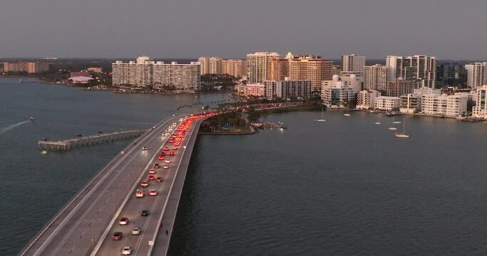 Evening aerial video of the Sarasota, Florida skyline and Ringling Parkway Bridge across Sarasota Bay	