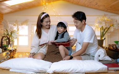 Fototapeta premium Happy Asian family spending time together at home.
