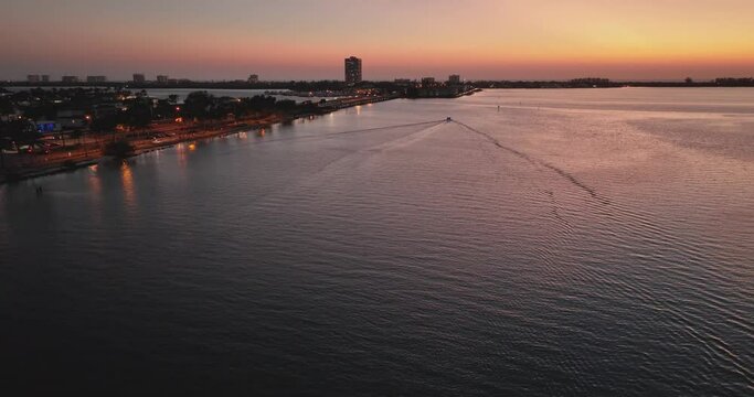 Evening aerial video of the sunset over Sarasota Bay and Lido Key near Sarasota, Florida.