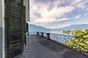 Terrace of an old villa overlooking the Lake Maggiore in Italy with mountains in the background