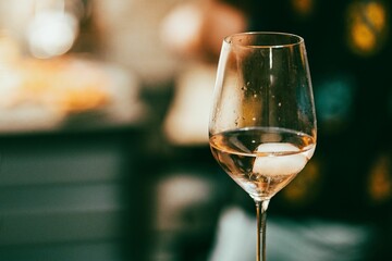 Shallow focus of a glass white wine with blurred background