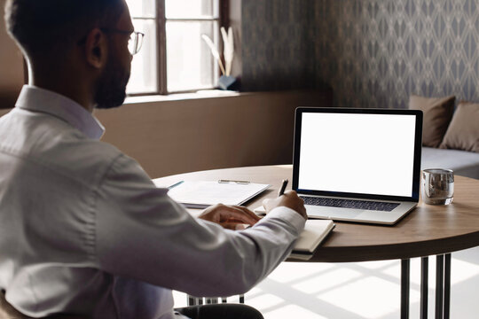 Young Man Using Laptop Computer With Blank Empty Mockup Screen. Business Man Working At Home. Freelance, Student Lifestyle, E-learning, Shopping Online, Web Site, Technology Concept