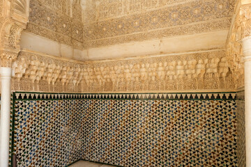 Alhambra, Detailed background of the Alhambra Palace with intricate tile patterns on the wall and...