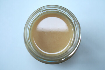Top view of open jar of honey