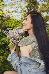 Facial close-up portrait of youthful female  posing against green trees, smiling widely, feeling free, enjoying hot summer day. 