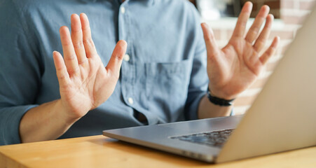 close up man hand gesture about finish sign language to teaching or learning from webinar in home for lifestyle concept
