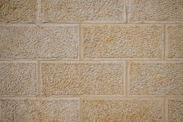 texture of a tiled beige stone wall as background, natural stone wall texture as background....