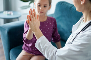 Fototapeta premium Doctor and kid patient giving Five to each other at home. Child patient at usual medical inspection. Medicine, healthcare concepts