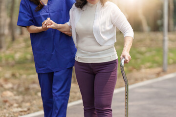 Healthcare nurse, physical therapy with elderly woman at outdoor. Nurse holding hand and help elderly woman