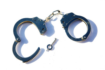 Handcuffs. Hinged Galvanized Handcuffs. Handcuffs isolated on white transparent background. Metal...