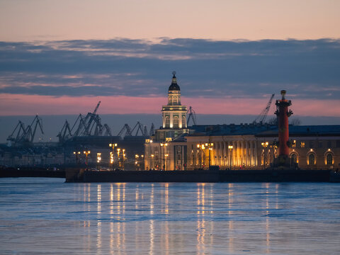 Duwn city center. Spring evening in St. Petersburg. Ice on the Neva River. View of the Rastral columns and Cabinet of curiosities at sunset, city life, postcard view of the evening city.