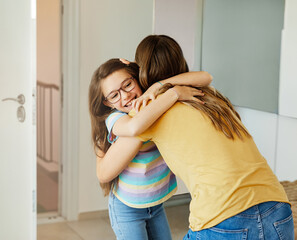 child mother daughter backpack house education school family student welcome hug together love woman elementary home girl woman