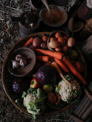 A traditional basket of fresh fruit and vegetables, organic products and eggs. Countryside produce, free range and healthy food, natural products.