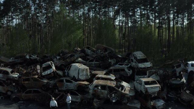 Footage of the car cemetery in Bucha, which has become a storage site for destroyed vehicles as a result of the war with Russia. Scenes show hundreds of cars that were wrecked, burned, and completely 