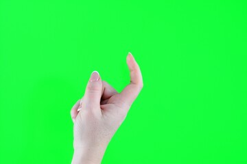beckon with a finger female index finger crooked reckoning come over here isolated on green...