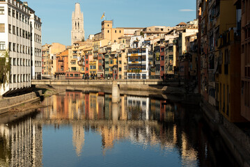 The colorful houses lining the riverbanks of Girona in Catalunya, Spain, add a picturesque charm to the city